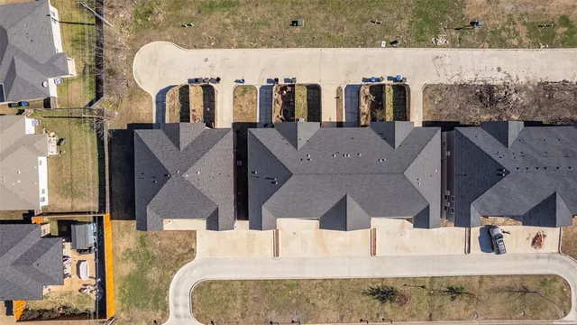 an aerial view of residential houses with yard