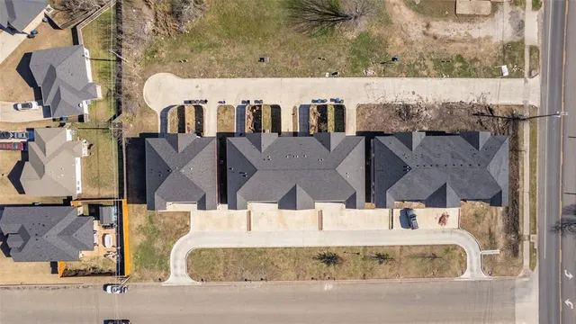 an aerial view of a house with wooden floor and city view