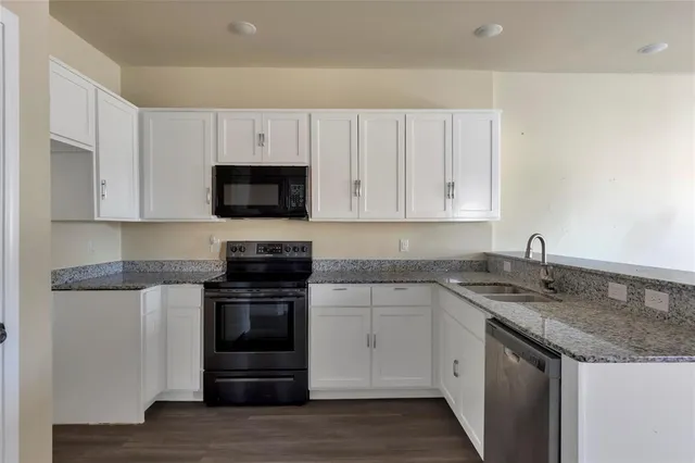 a kitchen with stainless steel appliances granite countertop a stove and a sink