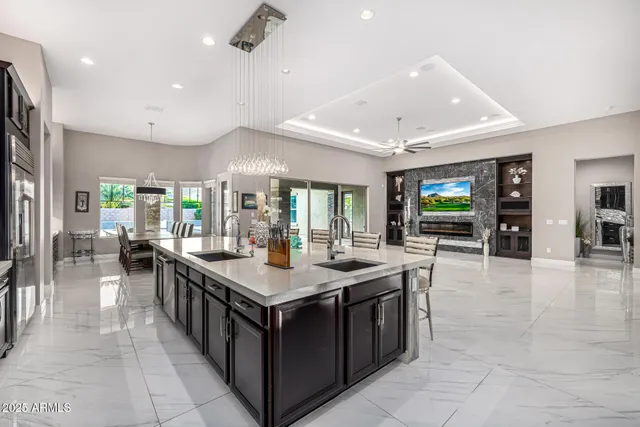 a front view of a house with garden and a tree