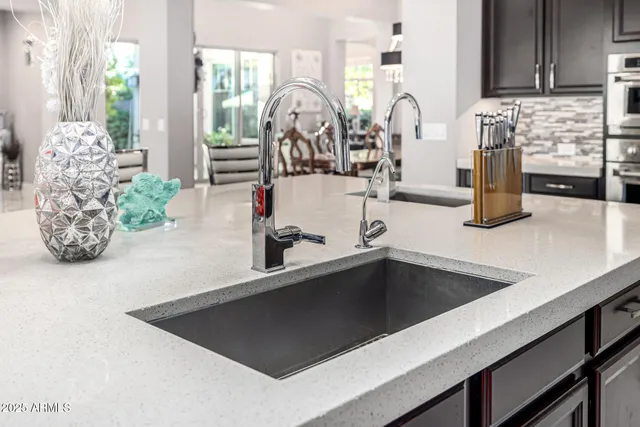 an aerial view of residential houses with outdoor space and parking