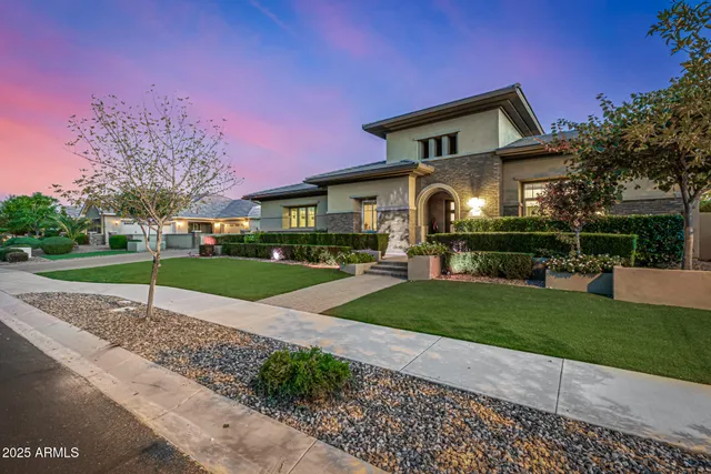 a front view of a house with a garden
