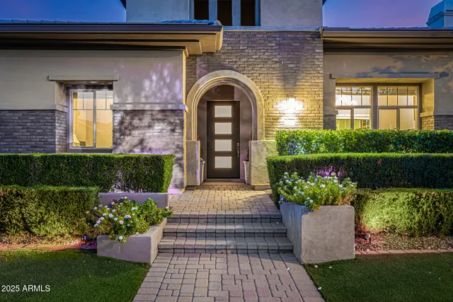 a view of a house with a yard and large parking space