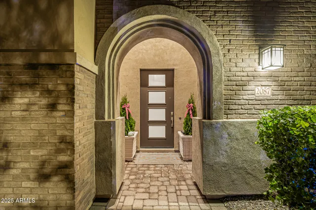 a view of a hallway to a livingroom with furniture