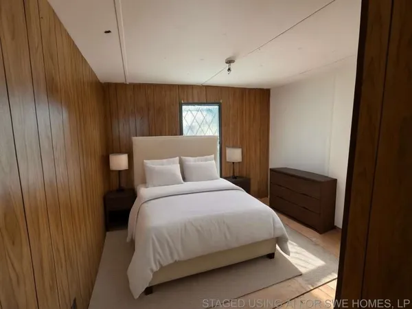 a bedroom with a bed and a window