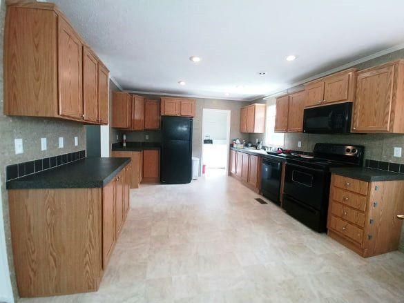 180 Factory Hill Road Callaway, VA 24067 - Photo 2 of 14 a kitchen with stainless steel appliances granite countertop a stove top oven a sink dishwasher a refrigerator and a microwave