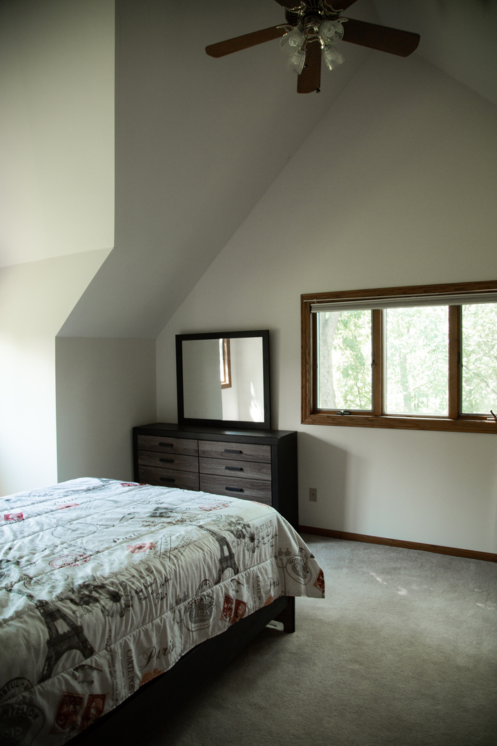 28W130 Roosevelt Road Winfield, IL 60190 - Photo 34 of 54 a bedroom with a bed and a window