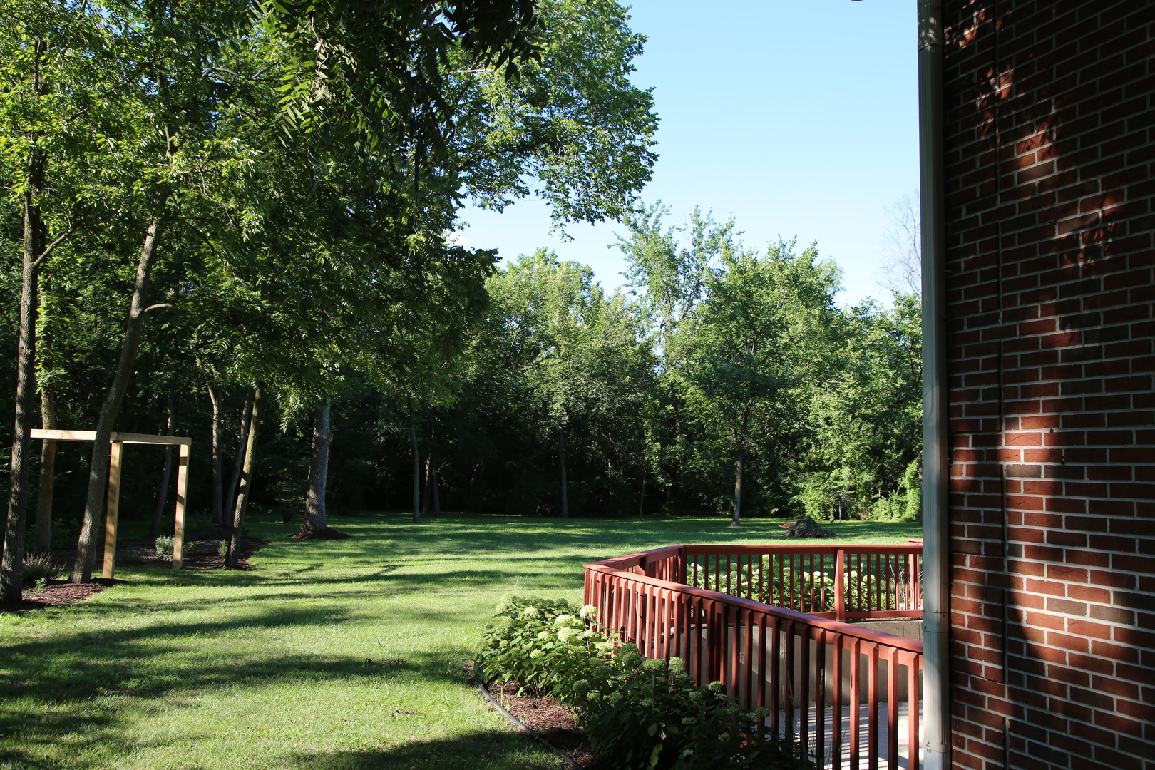 28W130 Roosevelt Road Winfield, IL 60190 - Photo 8 of 54 a view of a deck with a big yard and large trees