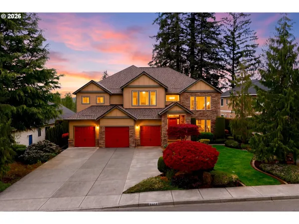 a front view of a house with a yard and garage