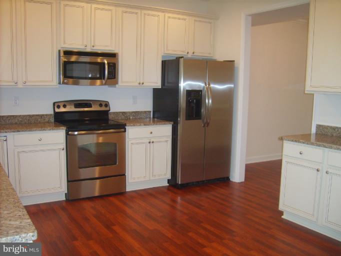 7720 North Point Road Edgemere, MD 21219 - Photo 12 of 22 a kitchen with a stove microwave and refrigerator