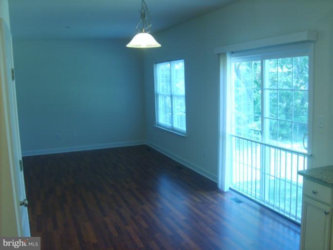 7720 North Point Road Edgemere, MD 21219 - Photo 3 of 22 a view of an empty room with wooden floor and a window