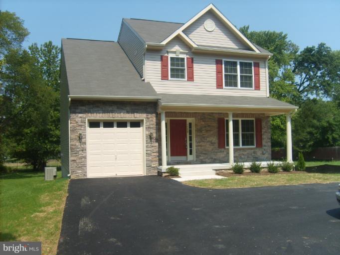 7720 North Point Road Edgemere, MD 21219 - Photo 22 of 22 a front view of a house with a yard and trees