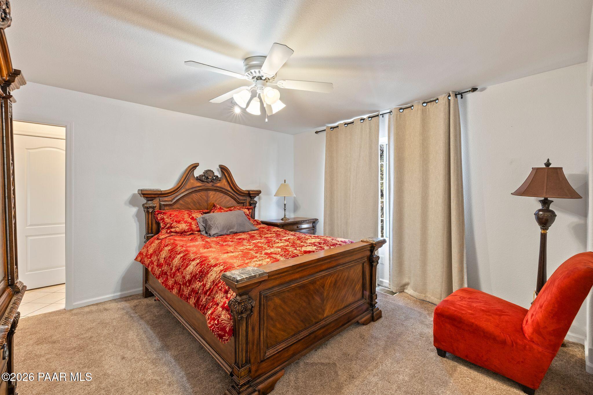 2015 Shadow Valley Ranch Road Prescott, AZ 86305 - Photo 13 of 42 a bedroom with a bed and a chandelier