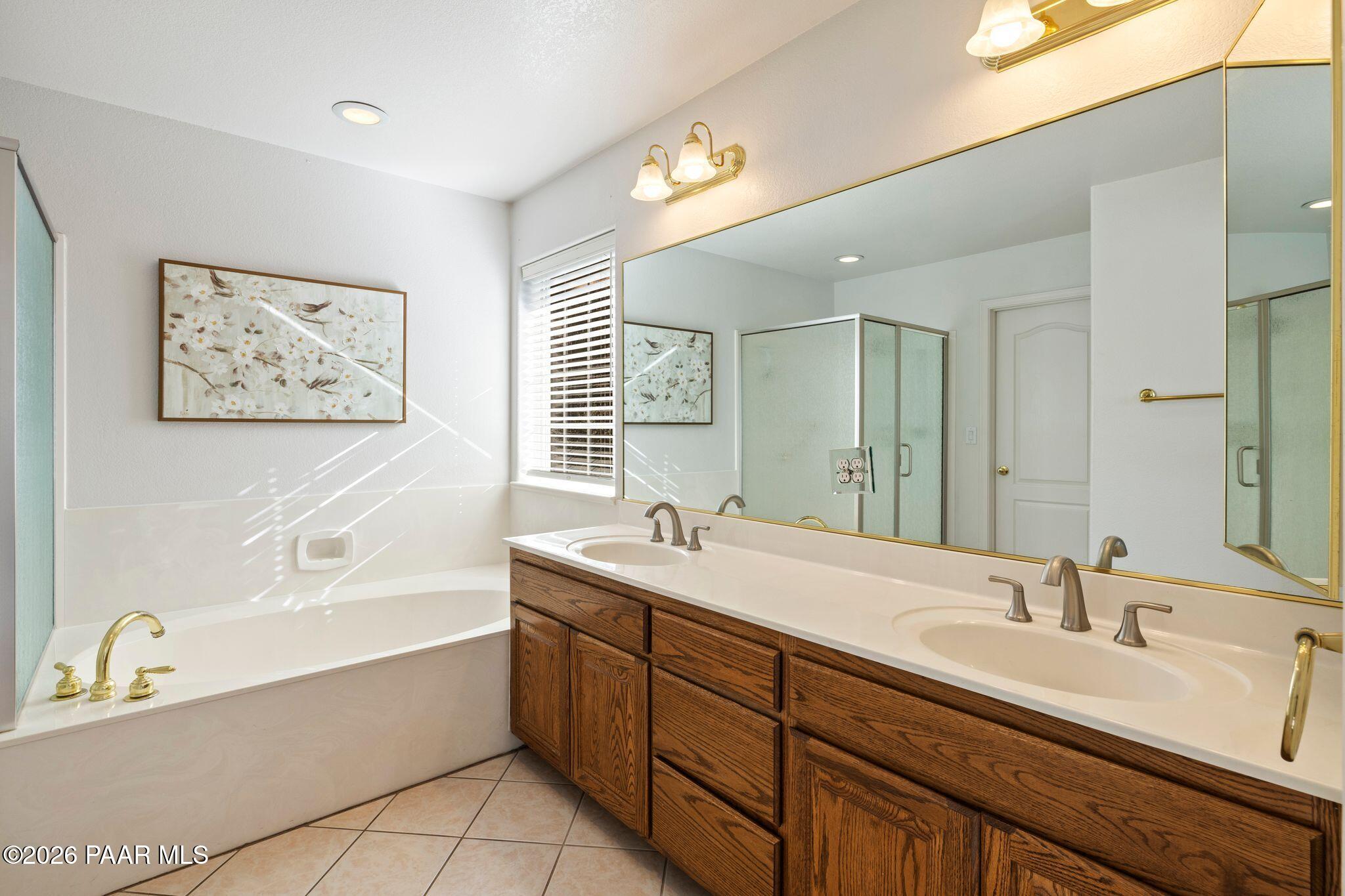 2015 Shadow Valley Ranch Road Prescott, AZ 86305 - Photo 18 of 42 a bathroom with a tub double sink window and mirror