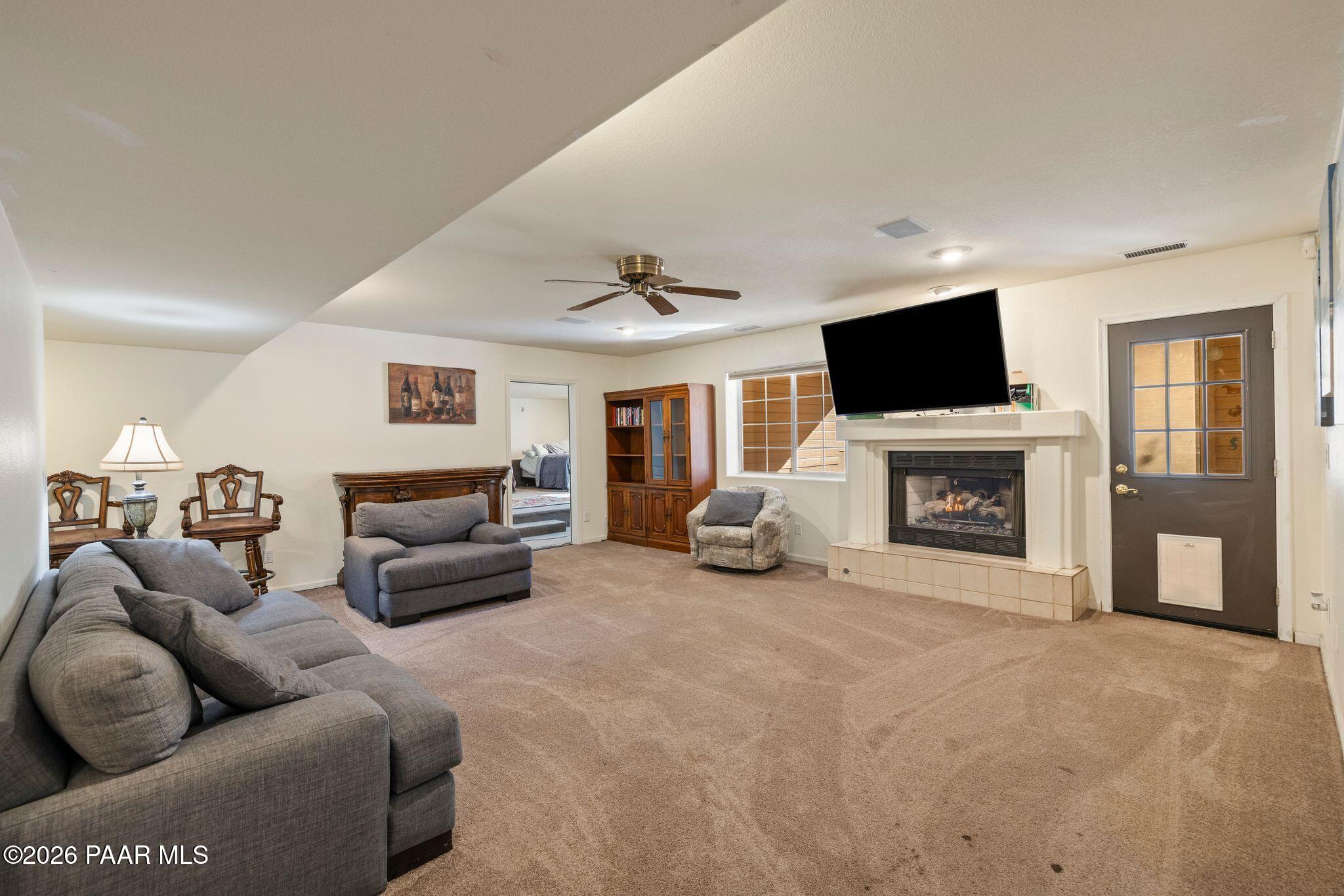 2015 Shadow Valley Ranch Road Prescott, AZ 86305 - Photo 23 of 42 a living room with furniture a fireplace and a flat screen tv