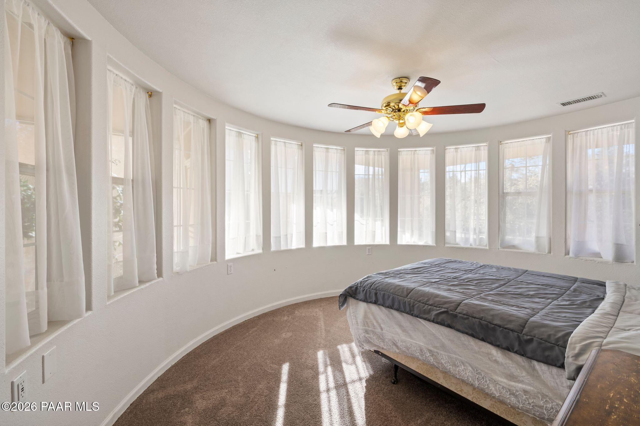 2015 Shadow Valley Ranch Road Prescott, AZ 86305 - Photo 27 of 42 a bedroom with a bed and a chandelier