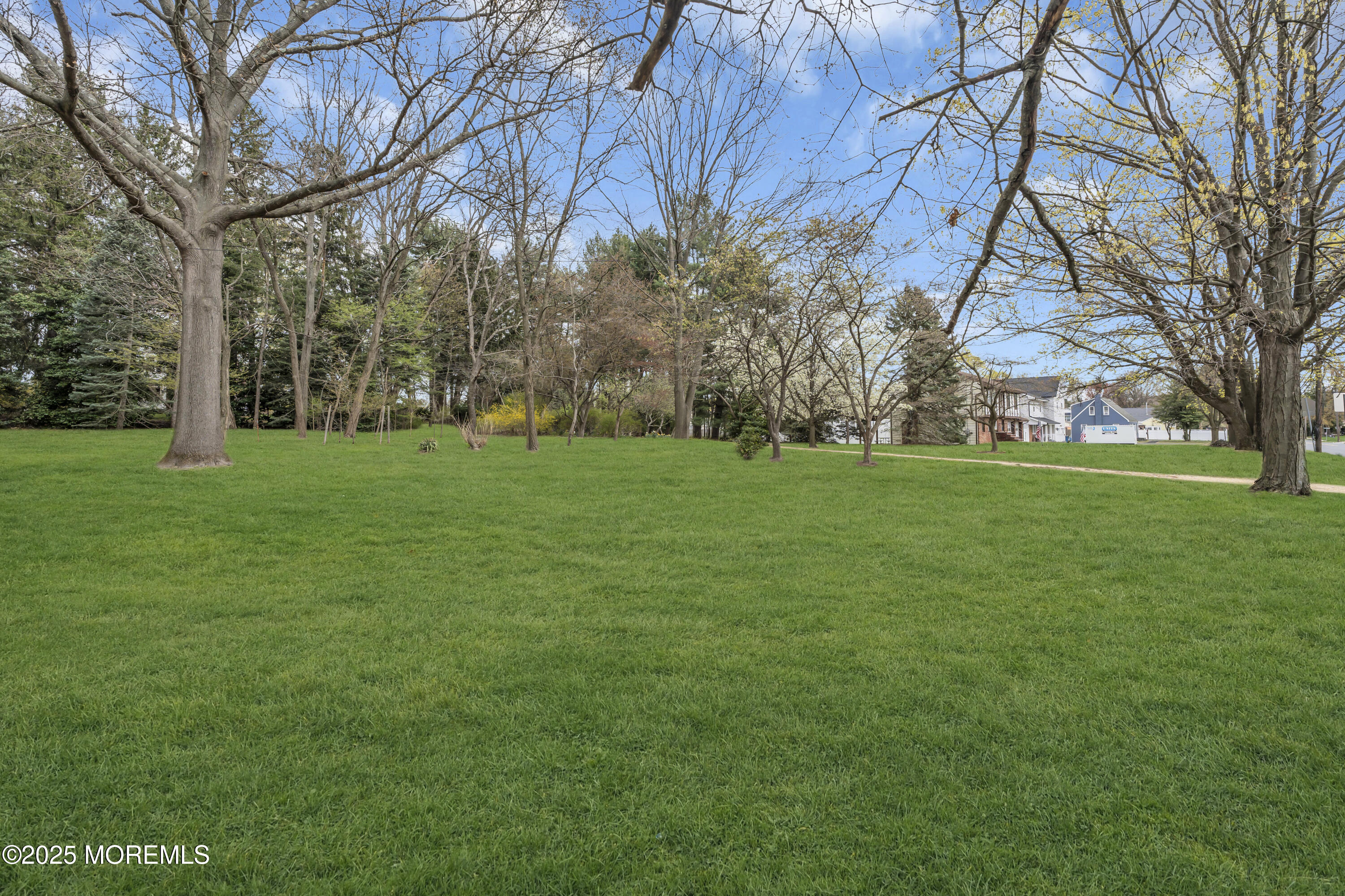 627 Beers Street Hazlet, NJ 07730 - Photo 13 of 64 a backyard of a house with lots of green space and fountain