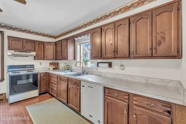 an empty room with a ceiling fan and wooden floor