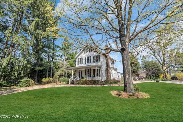 a front view of a house with a yard table and chairs