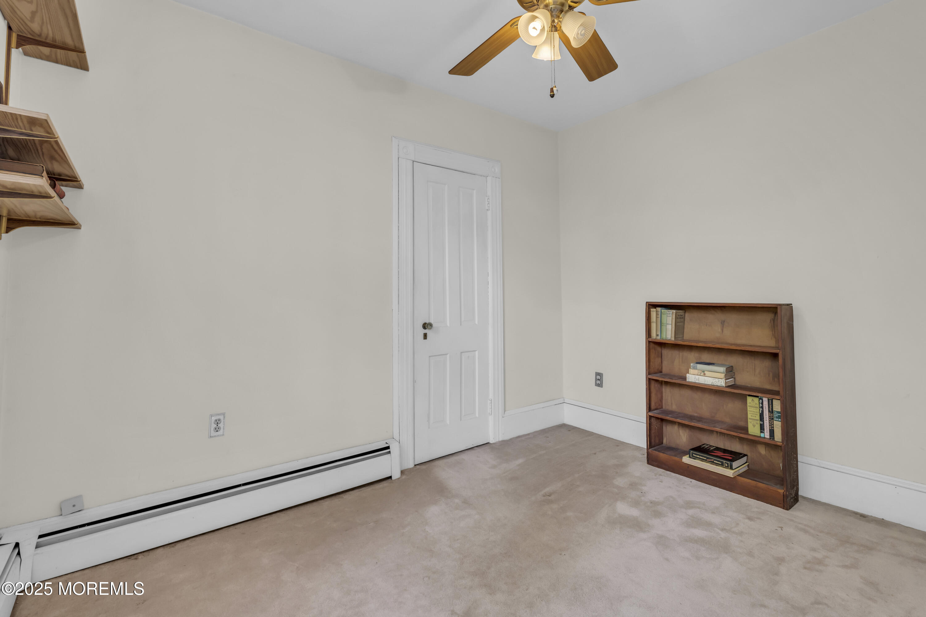 627 Beers Street Hazlet, NJ 07730 - Photo 33 of 64 an empty room with a ceiling fan and wooden floor