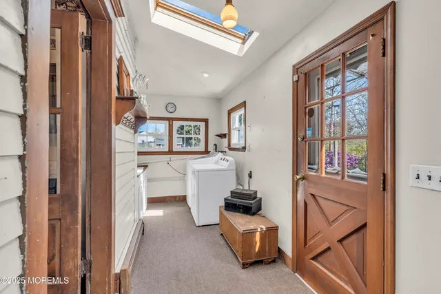 a front view of a house with a yard and trees