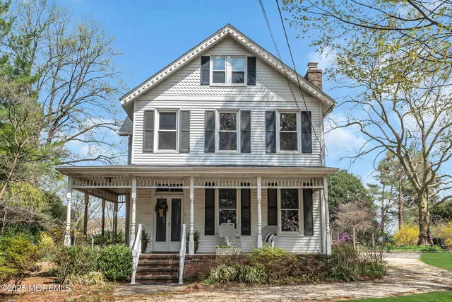 a front view of a house with outdoor seating and plants