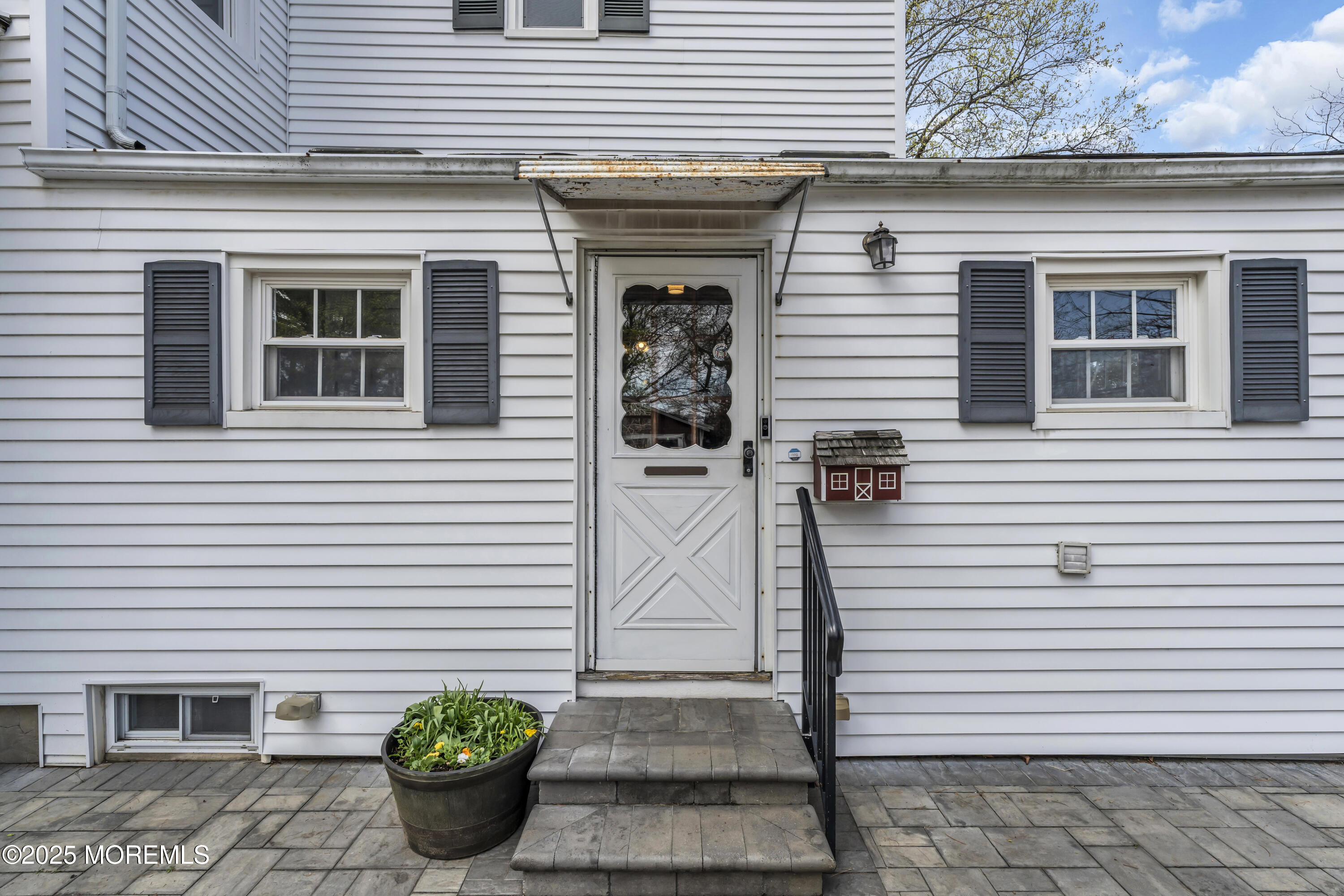 627 Beers Street Hazlet, NJ 07730 - Photo 56 of 64 a front view of a house with potted plants