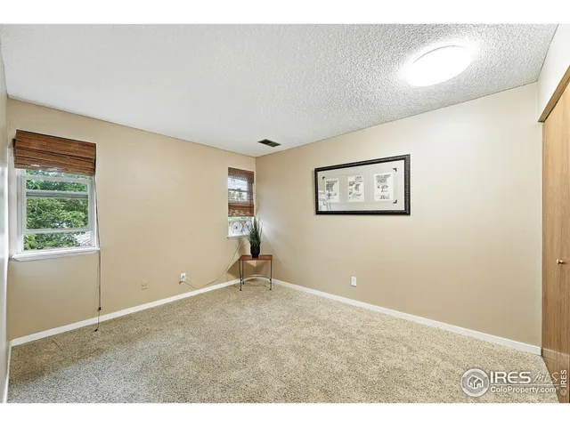 a bedroom with a bed and a chair