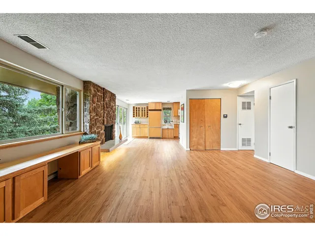 a big room with wooden floor and windows