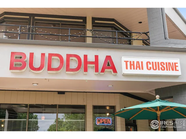 a group of people sitting outside of a building