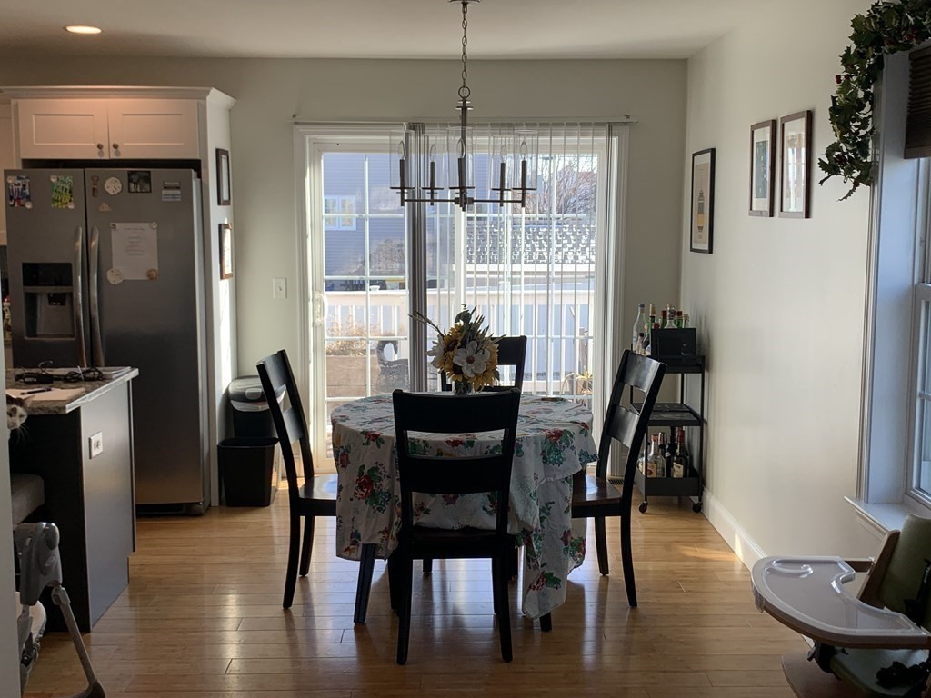 418 Smith Street Fall River, MA 02721 - Photo 13 of 37 a dining room with furniture a chandelier and wooden floor