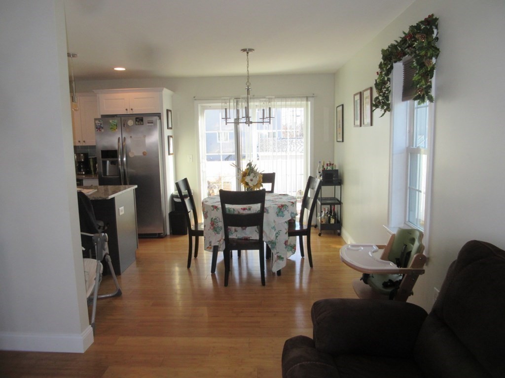 418 Smith Street Fall River, MA 02721 - Photo 14 of 37 a dining room with furniture a chandelier and wooden floor