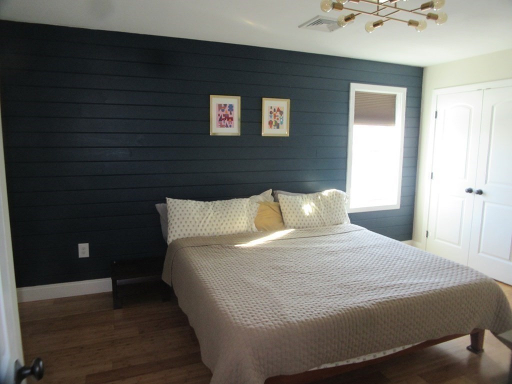 418 Smith Street Fall River, MA 02721 - Photo 22 of 37 a large bed sitting in a bedroom next to a window