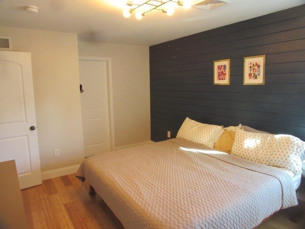 418 Smith Street Fall River, MA 02721 - Photo 24 of 37 a bedroom with a bed and wooden floor