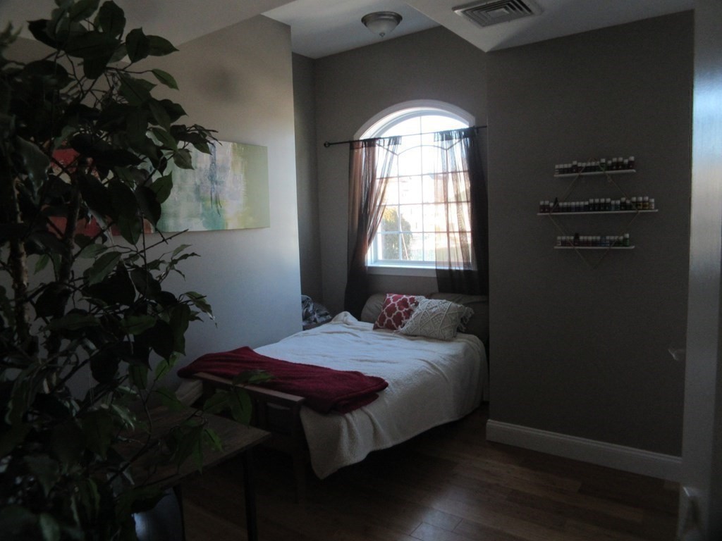 418 Smith Street Fall River, MA 02721 - Photo 28 of 37 a bed sitting in a bedroom next to a window