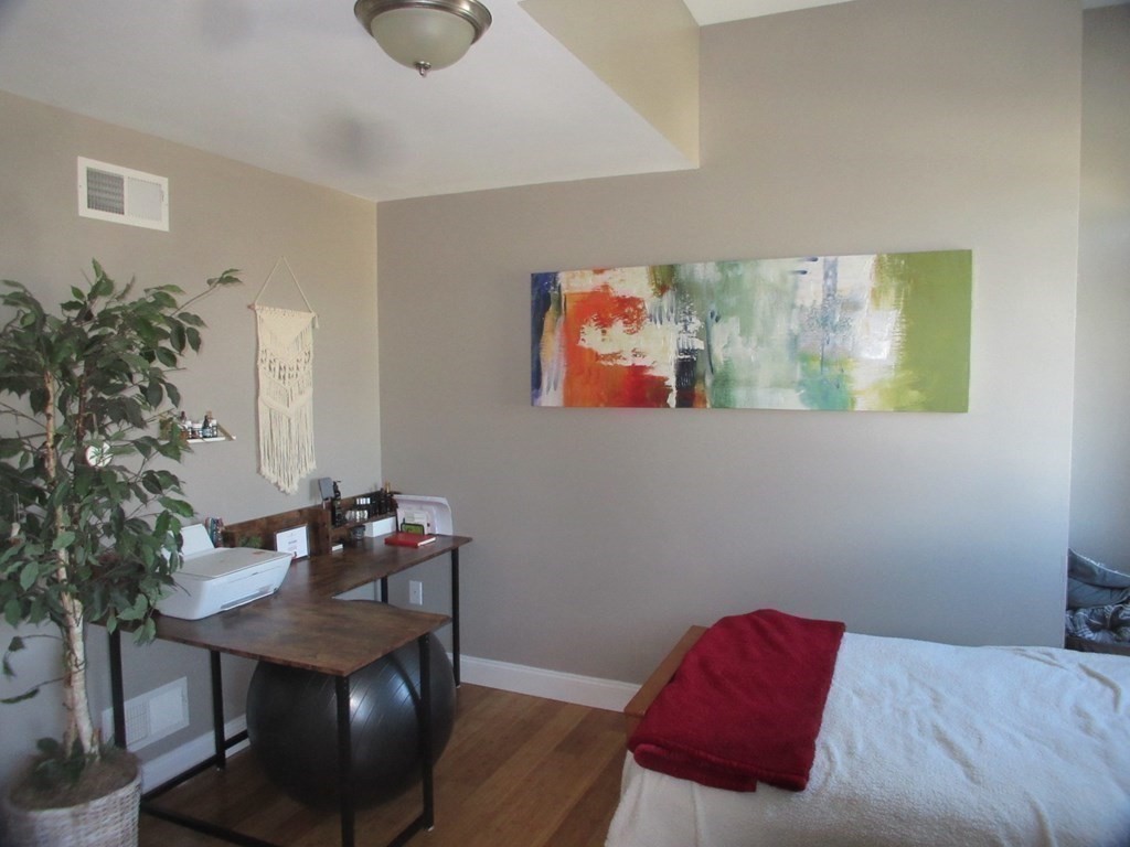 418 Smith Street Fall River, MA 02721 - Photo 29 of 37 a bedroom with a bed and a potted plant