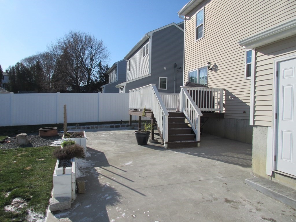 418 Smith Street Fall River, MA 02721 - Photo 5 of 37 a view of a patio with a table and chairs and a barbeque