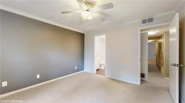 an empty room with closet and a chandelier fan