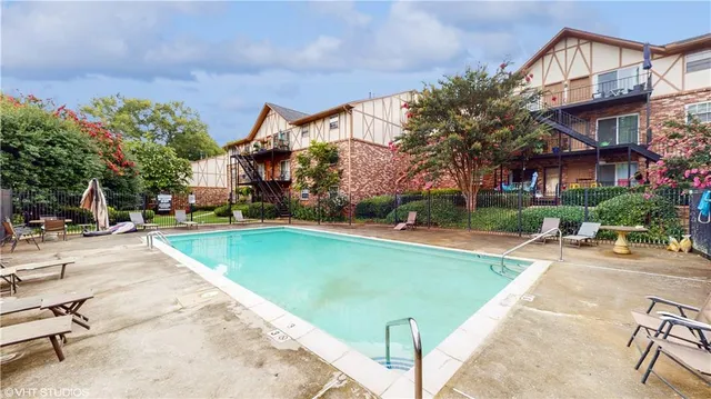 a view of a swimming pool with a patio