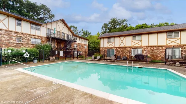 a view of house with swimming pool outdoor seating