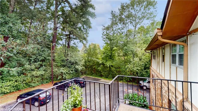 a roof deck with table and chairs under an umbrella