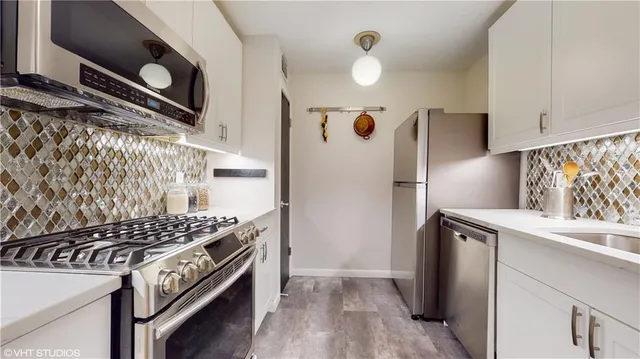 a kitchen with a stove and a refrigerator