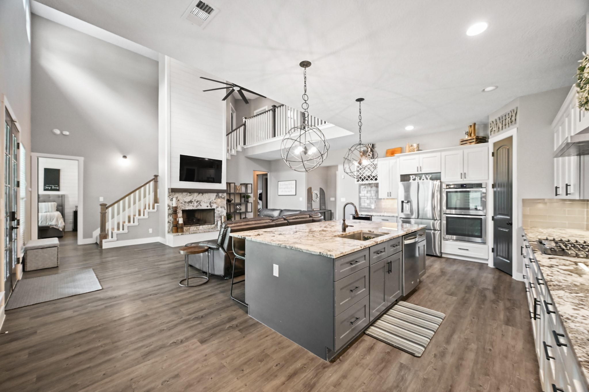 16912 Wagon Wheel Road Stagecoach, TX 77355 - Photo 17 of 39 a large kitchen with stainless steel appliances granite countertop a stove oven and a wooden floors