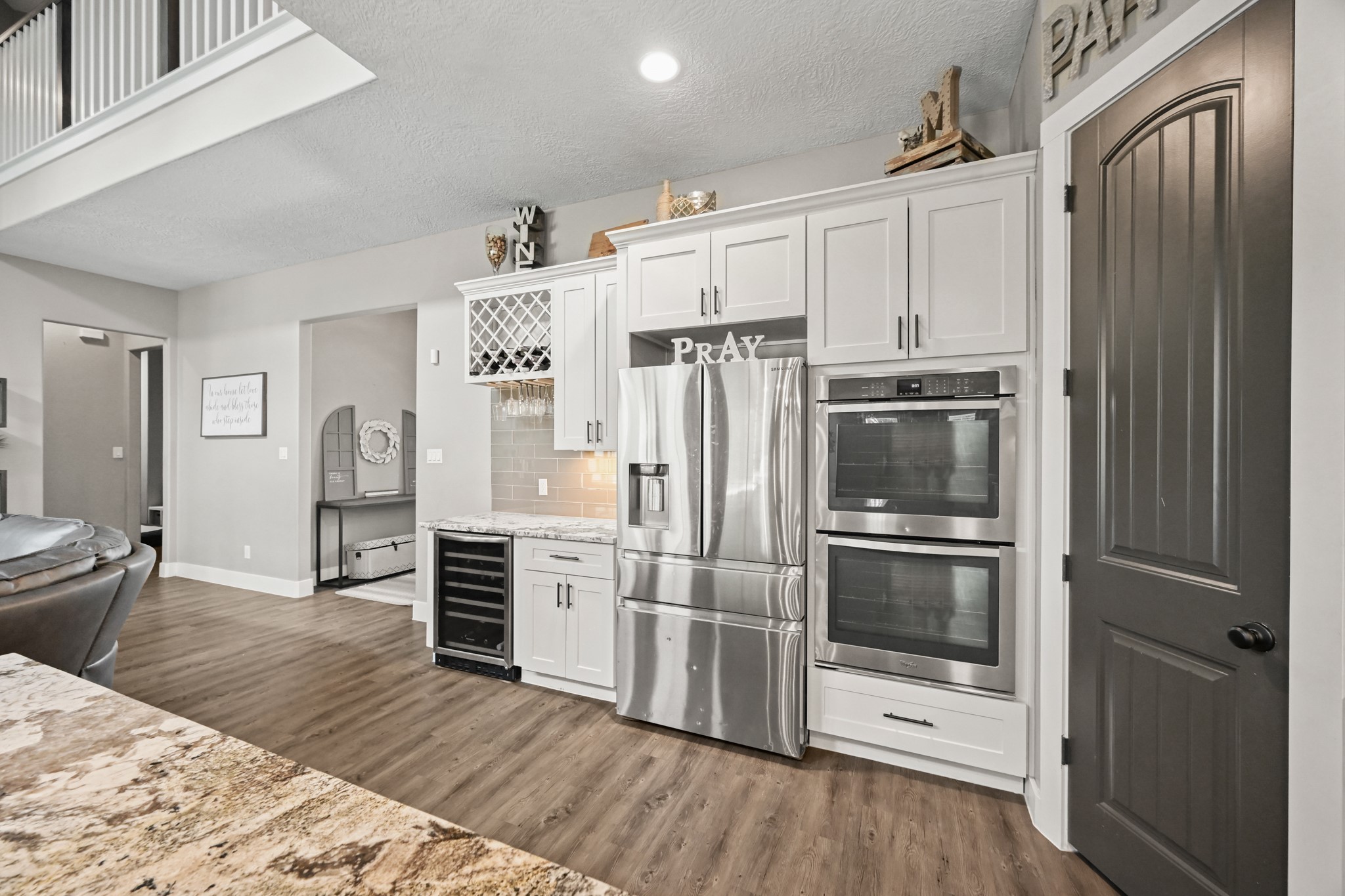16912 Wagon Wheel Road Stagecoach, TX 77355 - Photo 19 of 39 a kitchen with stainless steel appliances a refrigerator and wooden floor