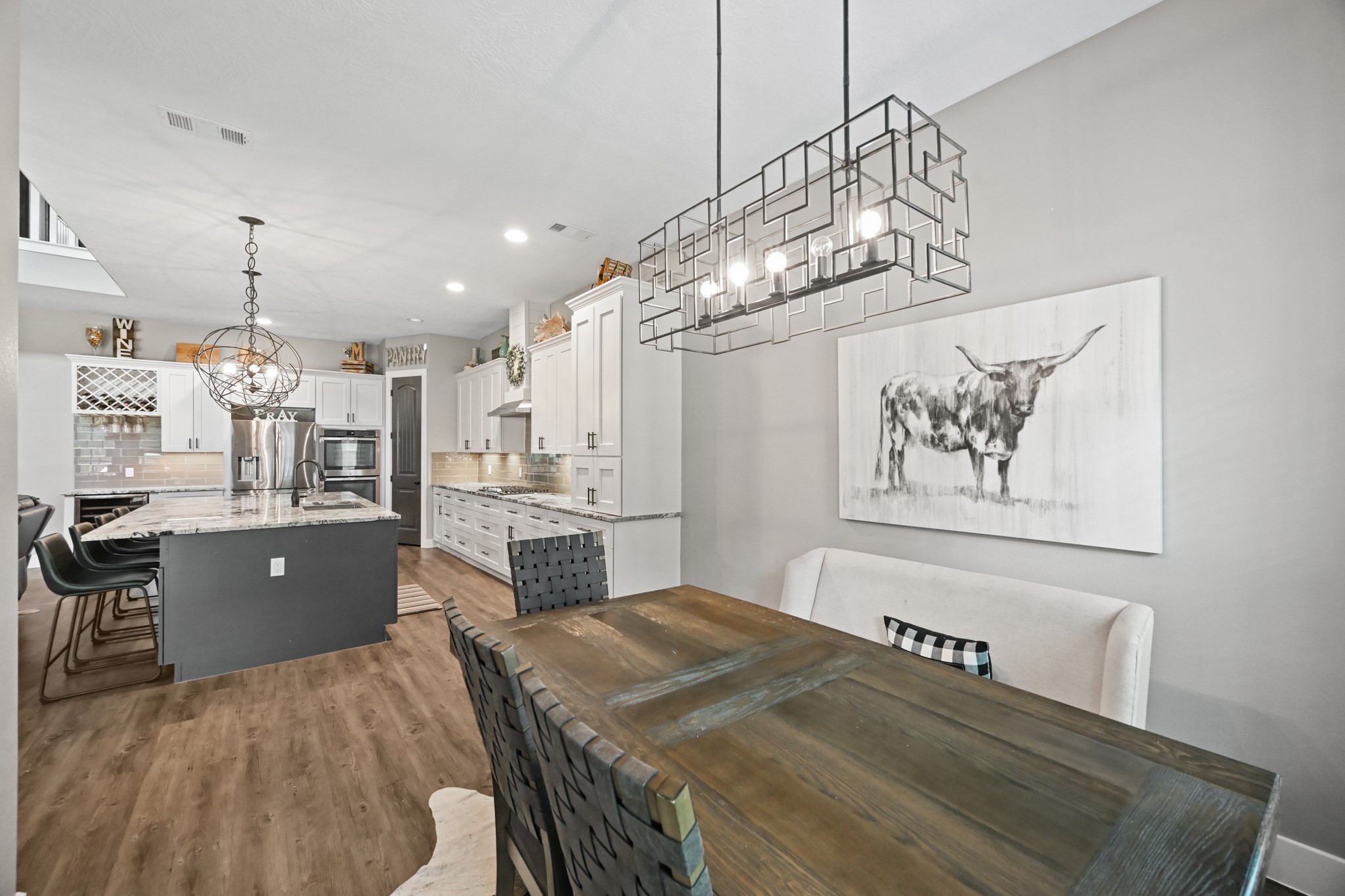 16912 Wagon Wheel Road Stagecoach, TX 77355 - Photo 20 of 39 Dedicated Dining Space next to the kitchen with unique lighting. Perfect for family meals and entertaining.