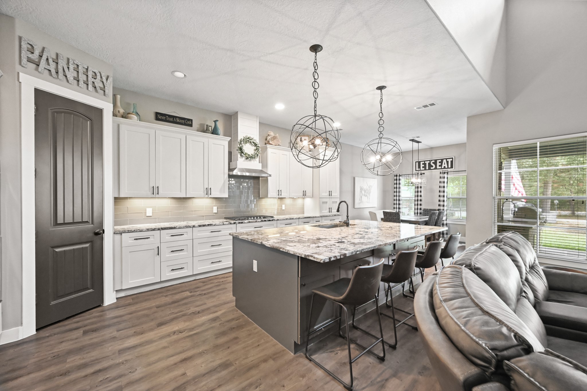 16912 Wagon Wheel Road Stagecoach, TX 77355 - Photo 21 of 39 View of the kitchen island from the living room, highlighting the abundant storage and counter space.