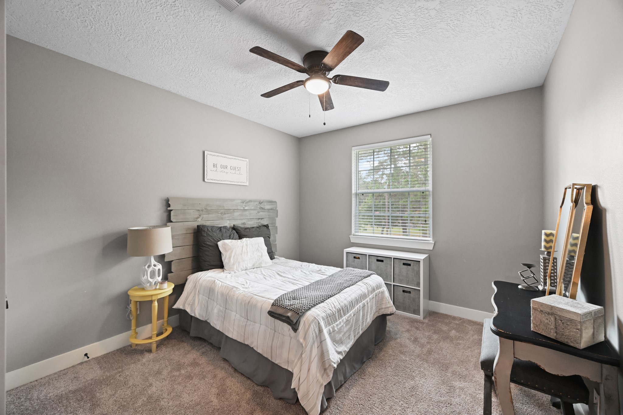 16912 Wagon Wheel Road Stagecoach, TX 77355 - Photo 34 of 39 Second Bedroom with carpet and large window views of the wooded lot.