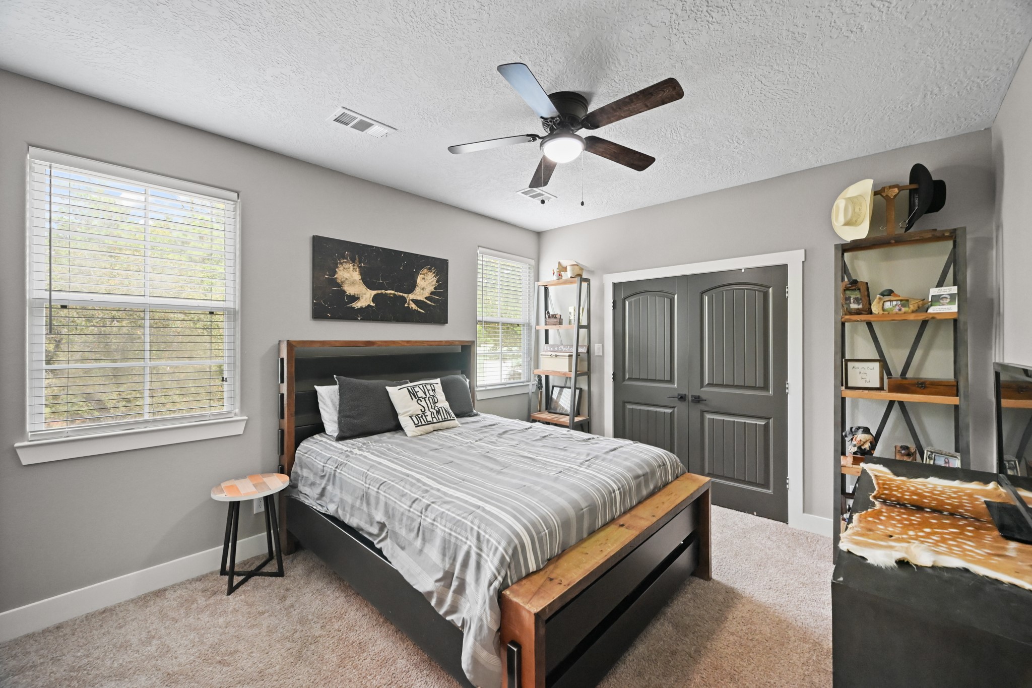 16912 Wagon Wheel Road Stagecoach, TX 77355 - Photo 36 of 39 a bedroom with a bed and a chandelier