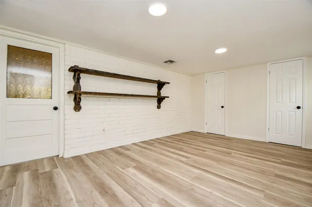 a view of a room with wooden floor and white walls