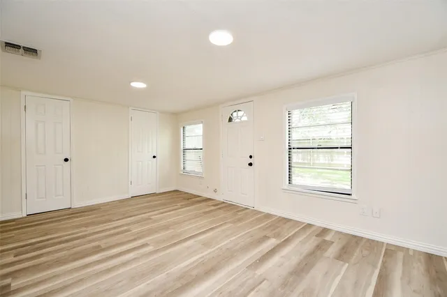 wooden floor in an empty room with a window